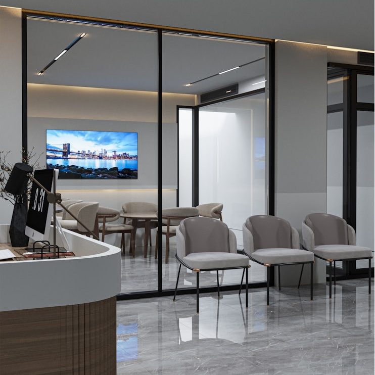 A modern office reception area with grey chairs and a large screen displaying a cityscape.